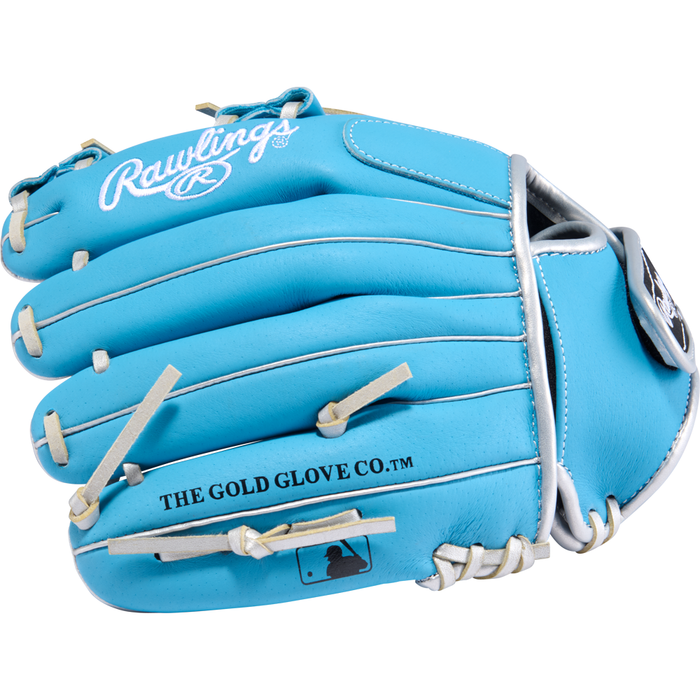 The Rawlings Sure Catch 11″ Brice Turang Youth Baseball Glove (SC110BT) is a vibrant blue infield glove featuring white laces, silver piping, and exterior logos displaying Rawlings and THE GOLD GLOVE CO.