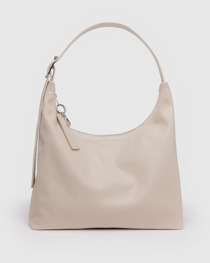 Light beige recycled leather shoulder bag with top handle and metal keychain charm