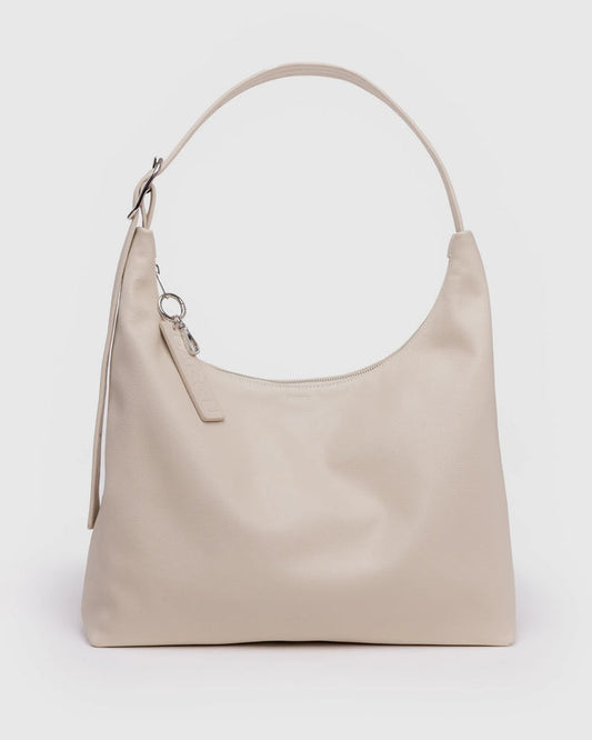 Light beige recycled leather shoulder bag with top handle and metal keychain charm