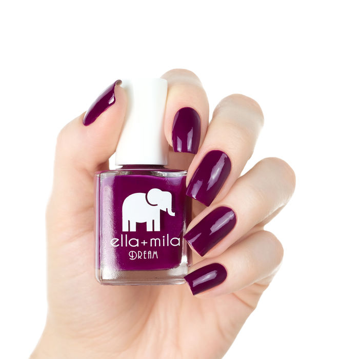 Rising Violet deep violet nail polish manicure on a light skin tone with the bottle