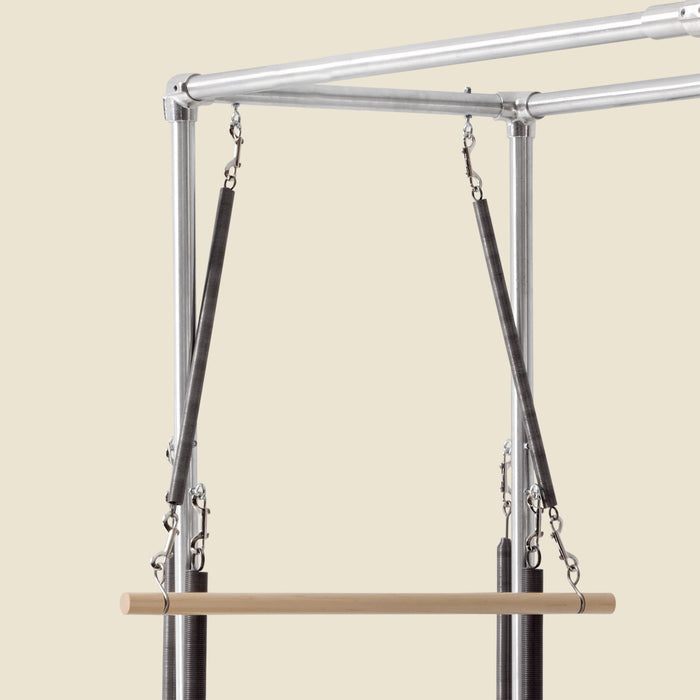 Pair of roll down bar springs clipped to a Cadillac frame above a wooden bar.
