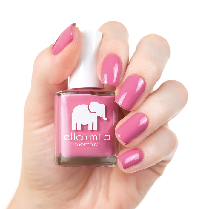 Rosy Cheeks rosy pink nail polish manicure on a light skin tone with the bottle