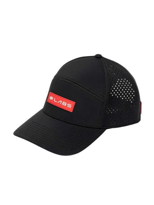 Three-quarter view of Selkirk LABS flat-bill snapback showcasing red LABS patch, perforated side panels on black background