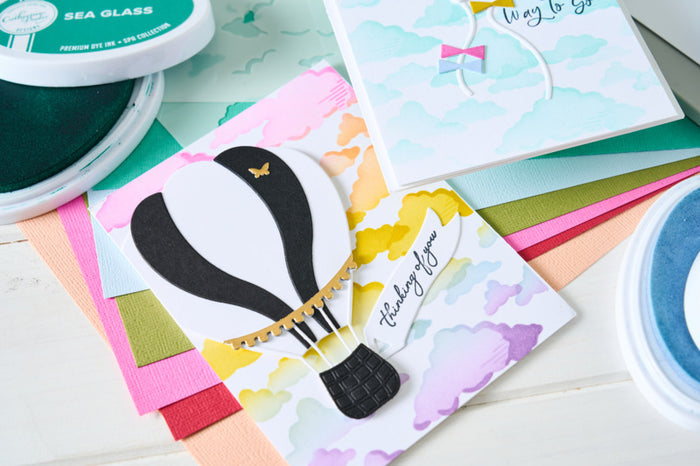 Sizzix - By Catherine Pooler - A6 Layered Stencils - In the Clouds (4pk). Available at Embellish Away located in Bowmanville Ontario Canada. Example by brand Ambassador.