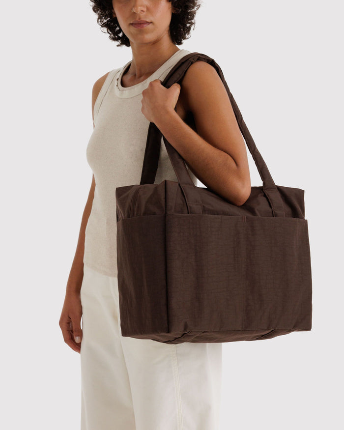 Brown carry-on tote bag worn on the shoulder with top handles