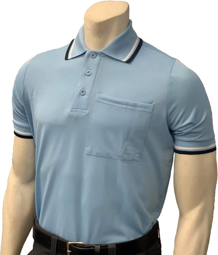 A mannequin wears a Smitty Pro Flex Umpire Polo Shirt (BB-S307)—light blue with black and white trim, chest pocket, stretch fabric for a professional fit—by Smitty, paired with black pants.