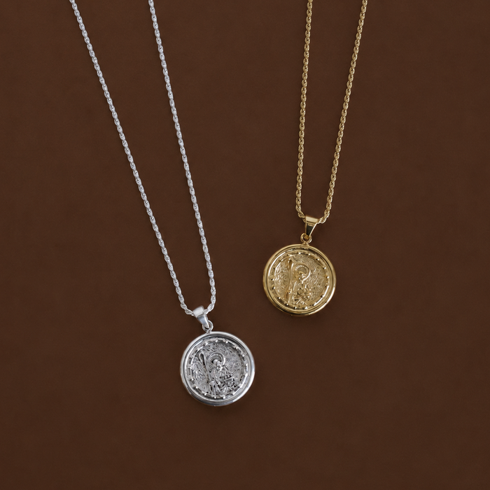 Two necklaces with circular pendants on a brown background