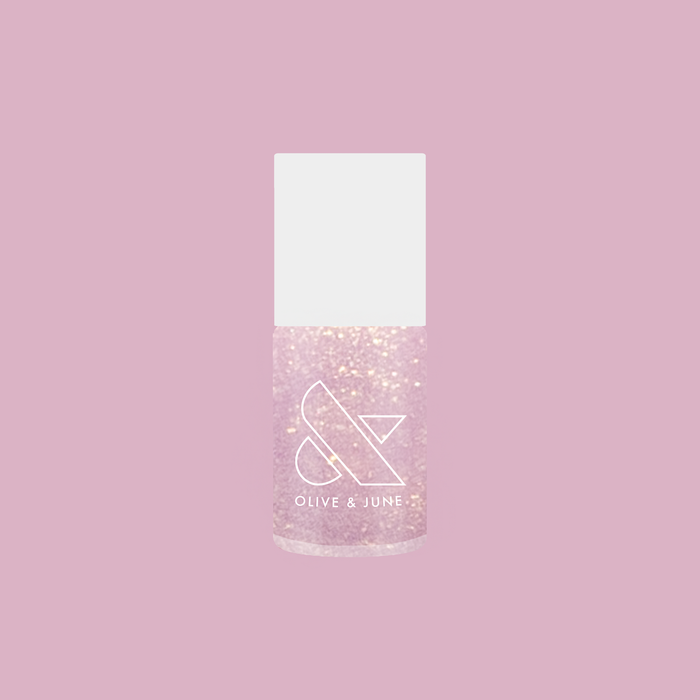 Olive and June Star Baker nail polish bottle with sheer iridescent lavender gel polish on soft pink background