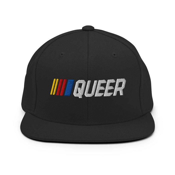 Black snapback flatbill cap with 'QUEER' in colorful letters on a white background