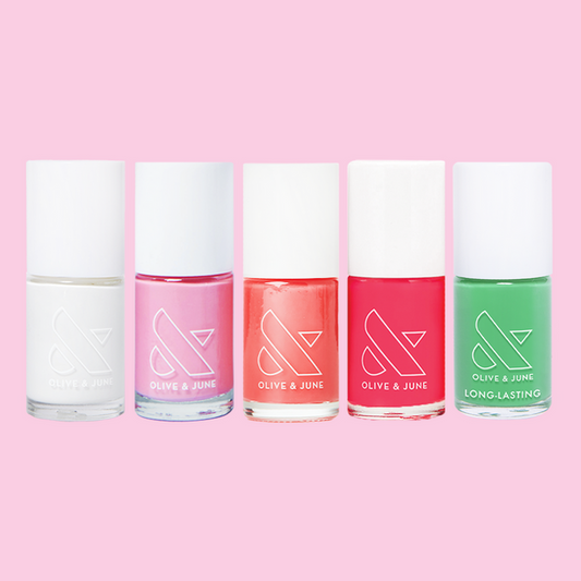 Summer Bestsellers Set with five bottles of quick dry nail polish in white, pink, coral, red, and green on pink background