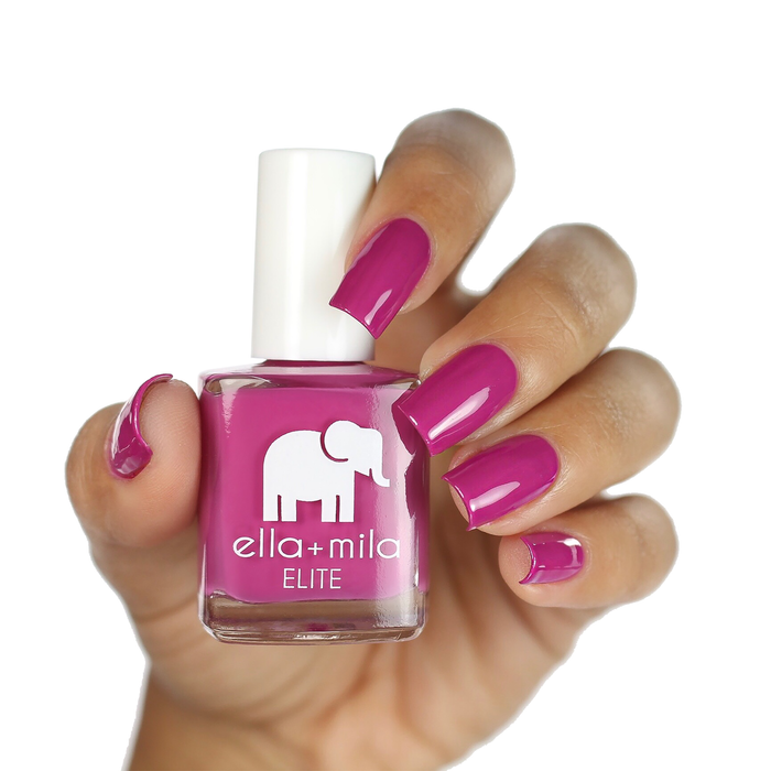 Summer Roam-ance berry dark pink nail polish on a medium skin tone, hand holding the bottle