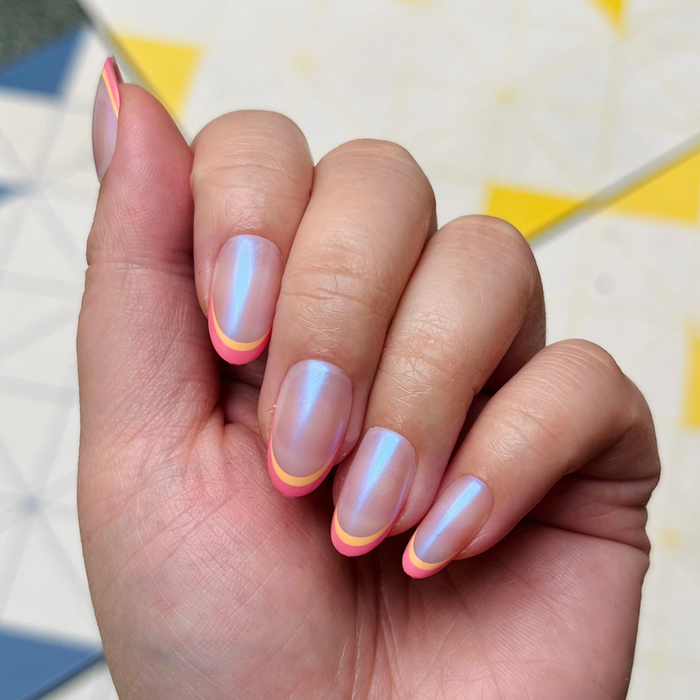 Sunset Double French - Press-On | Medium | Oval showing hand with medium oval iridescent nails and orange and magenta double french tips