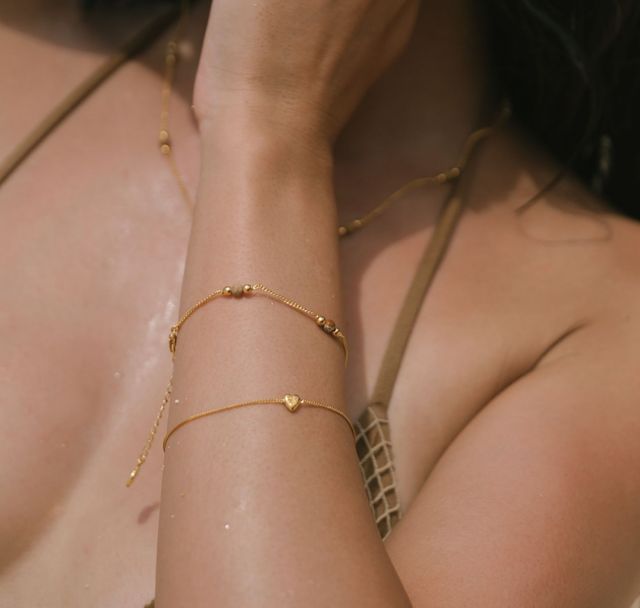 close up photo of  the sunstone necklace  gold on a woman