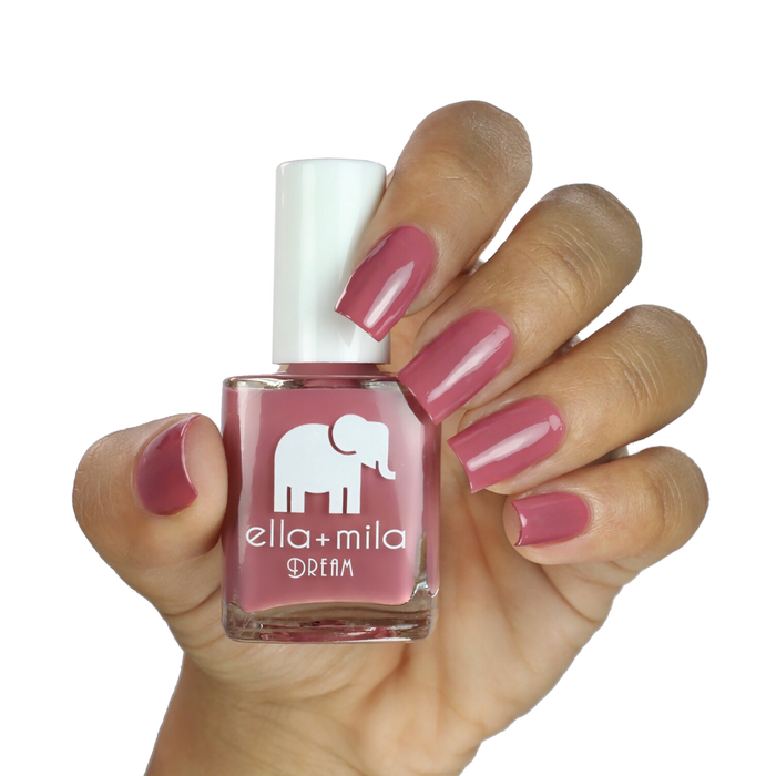 Time for a Bond-fire mauve nail polish on a medium skin tone, hand holding the bottle