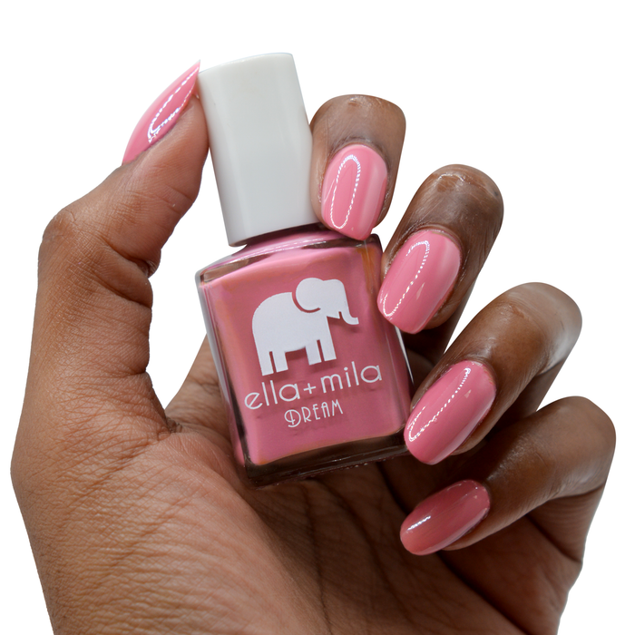 Time for a Bond-fire warm mauve nail polish on a deep skin tone, hand holding the bottle