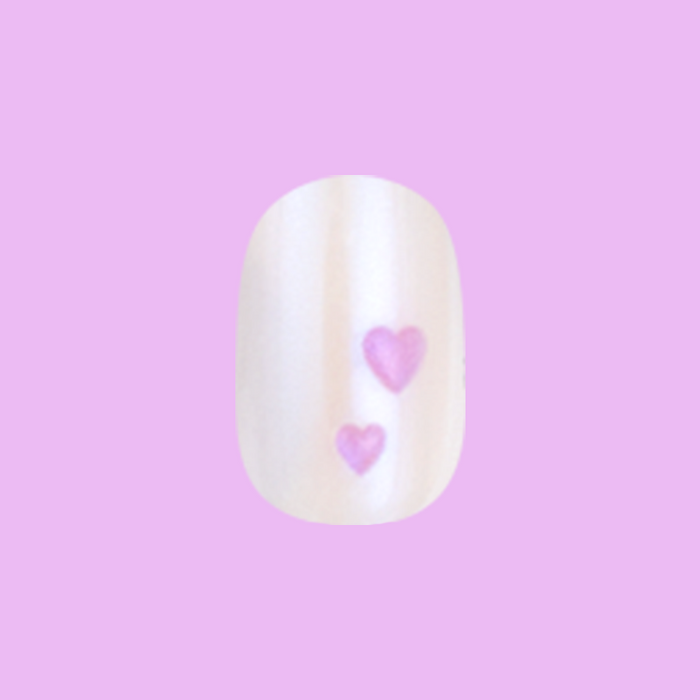 Tiny Puffy Hearts - Press-On | Short | Squoval showing single short squoval press-on nail with iridescent base and two pink hearts
