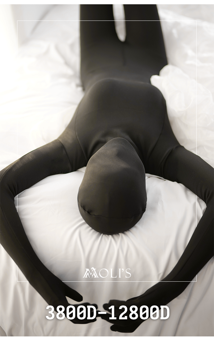 Male in black ultra-thick Molis Zentai suit from the Ultra+6800D/9800D/12800D series, full-body, close-up view.