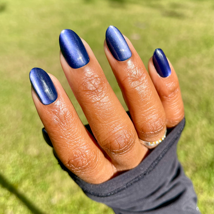 Velvet Rain - Press-On | Medium | Oval showing dark velvet blue medium oval press-on false nails on hand outdoors