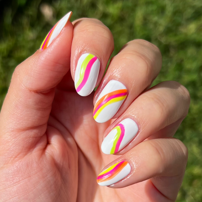 Vivid Era neon liners used for rainbow swirl nail art on white nails