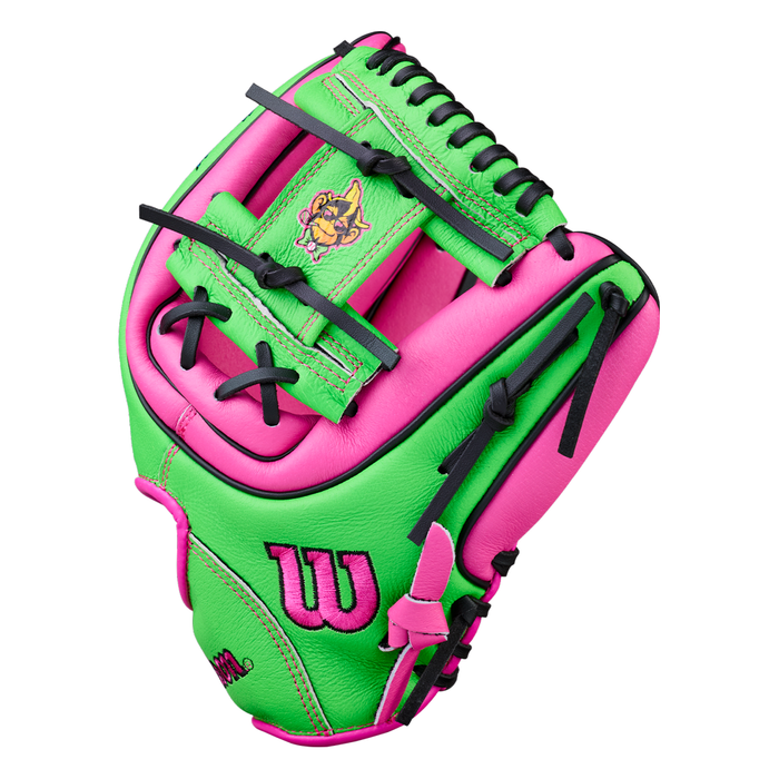 A vibrant neon green and pink Wilson A450 Party Animals 11″ Youth Baseball Glove (model WBW10419411) for youth, featuring black laces, the Wilson logo, and a small graphic of a monkey wearing sunglasses on the palm, all against a white background.
