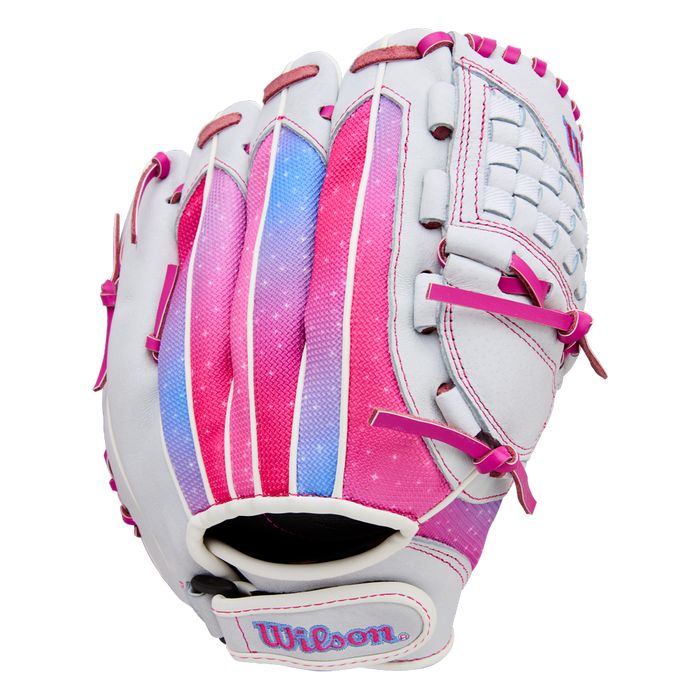 The Wilson Flash 11.5" Fastpitch Glove (WBW103985115) features a white design with pink, purple, and blue accents, pink laces, Wilson embroidered on the wrist strap, a woven web, and a gradient color pattern on the back.
