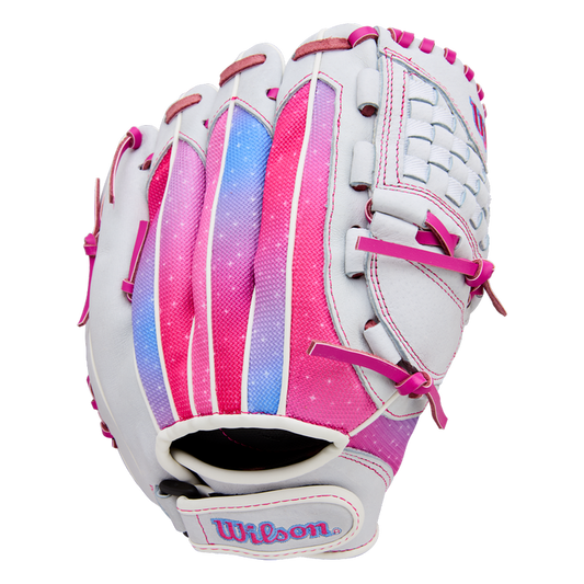 The Wilson Flash 11.5" Fastpitch Glove (WBW103985115) features a white design with pink, purple, and blue accents, pink laces, Wilson embroidered on the wrist strap, a woven web, and a gradient color pattern on the back.
