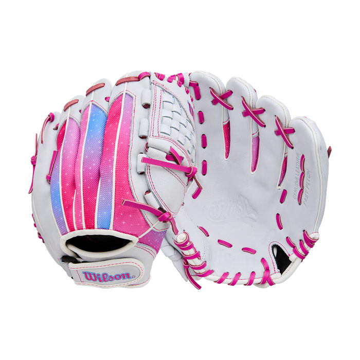 A pair of white Wilson Flash 11.5" Fastpitch Gloves (WBW103985115) with pink laces and accents are shown. The left glove displays a colorful pink, purple, and blue strip on the back, both set against a plain white background.